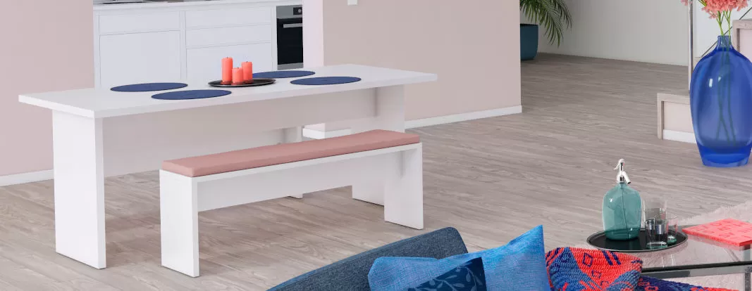 Dining table and bench in white decor in a kitchen with a display cabinet