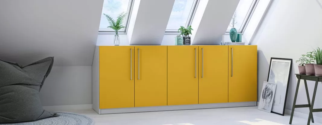 Sloped ceiling wardrobe with lacquered fronts in lemon yellow